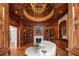 Elegant library with a cozy fireplace, built-in bookshelves and a comfortable curved sofa at 4560 Harris Trl, Atlanta, GA 30327