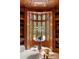 This home's library boasts floor-to-ceiling custom bookshelves and natural light from the bay window at 4560 Harris Trl, Atlanta, GA 30327