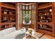 A cozy library with floor-to-ceiling bookshelves and natural light at 4560 Harris Trl, Atlanta, GA 30327
