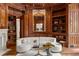 Home library showcasing custom millwork, bookshelves, decor, and an ornate gilded mirror at 4560 Harris Trl, Atlanta, GA 30327