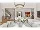 Bright and airy living room with marble top coffee tables, staircase, and gallery at 4560 Harris Trl, Atlanta, GA 30327