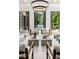 Elegant living room with modern furnishings, a view of the pool, and three sets of black framed glass doors at 4560 Harris Trl, Atlanta, GA 30327