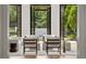 Bright living room with hardwood floors, modern furniture, and three sets of black framed glass doors at 4560 Harris Trl, Atlanta, GA 30327
