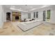 Spacious living room with a stone fireplace, large sectional sofa, and abundant natural light at 4560 Harris Trl, Atlanta, GA 30327
