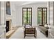 Cozy living room with a fireplace, comfortable seating, and large windows for natural light at 4560 Harris Trl, Atlanta, GA 30327