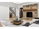 Inviting living room featuring a stone fireplace, a modern coffee table, and comfortable white seating at 4560 Harris Trl, Atlanta, GA 30327
