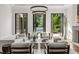 Spacious living room featuring modern decor, ample seating, and three sets of French doors providing ample natural light at 4560 Harris Trl, Atlanta, GA 30327