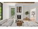 Bright and airy living room with a fireplace, stylish furnishings, and access to outdoor views at 4560 Harris Trl, Atlanta, GA 30327