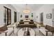Bright main bedroom featuring sitting area, chandelier, and large windows for a light-filled and airy feel at 4560 Harris Trl, Atlanta, GA 30327
