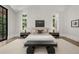 Comfortable bedroom with sleek decor, including a modern bench, and large windows that allow ample natural light at 4560 Harris Trl, Atlanta, GA 30327
