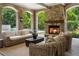 Inviting covered outdoor space with stone fireplace and comfortable seating, perfect for relaxation by the pool at 4560 Harris Trl, Atlanta, GA 30327