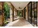 Covered patio with brick arches, stone flooring, and views of the surrounding greenery, offering a relaxing outdoor space at 4560 Harris Trl, Atlanta, GA 30327