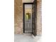 Elegant powder room featuring a pedestal sink, brick exterior, and modern fixtures at 4560 Harris Trl, Atlanta, GA 30327