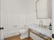Charming powder room featuring marble counters, gold fixtures and wood paneling at 4560 Harris Trl, Atlanta, GA 30327