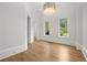 Bright room with wood floors, crown molding, and large windows overlooking the manicured greenery at 4560 Harris Trl, Atlanta, GA 30327