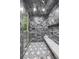 Modern shower featuring marble style tile, rain shower head, and a built-in bench at 4560 Harris Trl, Atlanta, GA 30327