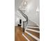 Elegant staircase with hardwood steps, white risers, and a black iron railing at 4560 Harris Trl, Atlanta, GA 30327