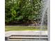 Elegant pool featuring a decorative water feature and steps into the pool at 4560 Harris Trl, Atlanta, GA 30327