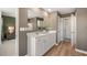 A lovely bathroom showcases a large mirror, double vanity, wood floors, and access to the commode and shower area at 4954 Jatoba Rd # 72, Acworth, GA 30101