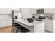 Modern kitchen features white cabinets, stainless steel appliances, a subway tile backsplash, and a large island with barstool seating at 4954 Jatoba Rd # 72, Acworth, GA 30101