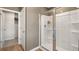 This newly installed shower features a glass door, tiled walls, and built in shelving for bathing essentials at 4954 Jatoba Rd # 72, Acworth, GA 30101