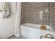 Stylish bathroom showcasing a mosaic tiled wall, bathtub, and modern fixtures for spa-like feel at 710 Oakview Rd, Decatur, GA 30030