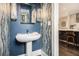 Stylish powder room features a pedestal sink, modern lighting, and unique textured wallpaper at 710 Oakview Rd, Decatur, GA 30030