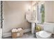 Clean bathroom with pedestal sink, natural light, and neutral tones for a calming atmosphere at 710 Oakview Rd, Decatur, GA 30030