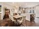 Dining room with modern light fixture, hardwood floors, and stainless steel appliances at 710 Oakview Rd, Decatur, GA 30030