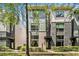 Modern townhouse with brick facade and large windows, surrounded by lush greenery at 710 Oakview Rd, Decatur, GA 30030