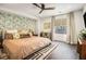 Comfortable bedroom with hardwood floors, designer wallpaper, and a large window with natural light at 710 Oakview Rd, Decatur, GA 30030