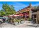 A bustling restaurant patio adorned with cafe tables, umbrellas, and vibrant floral arrangements on a sunny day at 710 Oakview Rd, Decatur, GA 30030