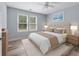 Well-lit bedroom featuring a neutral color palette, ceiling fan, and light wood flooring at 16104 Waldrop Cv, Decatur, GA 30034