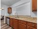Stylish kitchen featuring granite countertops, stainless steel appliances, and wood-look flooring at 16104 Waldrop Cv, Decatur, GA 30034