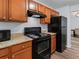 Well-equipped kitchen with sleek black appliances and warm-toned cabinets at 16104 Waldrop Cv, Decatur, GA 30034