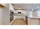 Bright kitchen featuring stainless steel appliances, including dishwasher, microwave, and an oven, with white cabinets and granite counters at 1708 Bouquet Way, Mcdonough, GA 30253