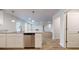 Bright modern kitchen with white cabinets, stainless steel appliances, granite countertops, and wood flooring at 1708 Bouquet Way, Mcdonough, GA 30253