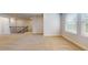 Spacious living area with carpeted flooring and a staircase, featuring natural light and neutral walls at 1708 Bouquet Way, Mcdonough, GA 30253
