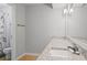 Well-lit bathroom with double sinks and granite countertops, next to the shower and toilet area at 212 Brittany Ct, Duluth, GA 30096