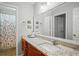 Bright bathroom with a vanity, granite countertop, a sink, and a shower with a floral curtain at 212 Brittany Ct, Duluth, GA 30096