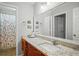 Beautiful bathroom featuring granite counters, cherry cabinets, a large mirror, and a floral shower curtain at 212 Brittany Ct, Duluth, GA 30096