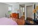 Comfortable bedroom with hardwood floors, a metal bed frame, dresser, and neutral paint that creates a warm ambiance at 212 Brittany Ct, Duluth, GA 30096
