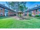 Exterior view of community buildings with a gazebo in the grassy courtyard area at 212 Brittany Ct, Duluth, GA 30096