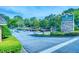 Entrance sign for Hampton Arbors community, with a stone base and manicured landscaping at 212 Brittany Ct, Duluth, GA 30096