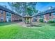 Apartment complex with a gazebo surrounded by a grassy lawn and lush landscaping at 212 Brittany Ct, Duluth, GA 30096