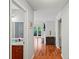 Hallway view showcases hardwood flooring and a glimpse into other rooms, including the bathroom at 212 Brittany Ct, Duluth, GA 30096