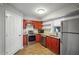 Efficient kitchen featuring cherry cabinets, stainless appliances, and modern countertops at 212 Brittany Ct, Duluth, GA 30096