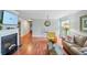 Bright living room featuring hardwood floors, a fireplace, and ample seating at 212 Brittany Ct, Duluth, GA 30096