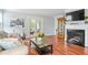 Comfortable living room with fireplace, wood floors, patio doors, and views of the outside at 212 Brittany Ct, Duluth, GA 30096