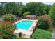 Inviting pool area surrounded by lush greenery and colorful flowering bushes for a peaceful and picturesque setting at 212 Brittany Ct, Duluth, GA 30096